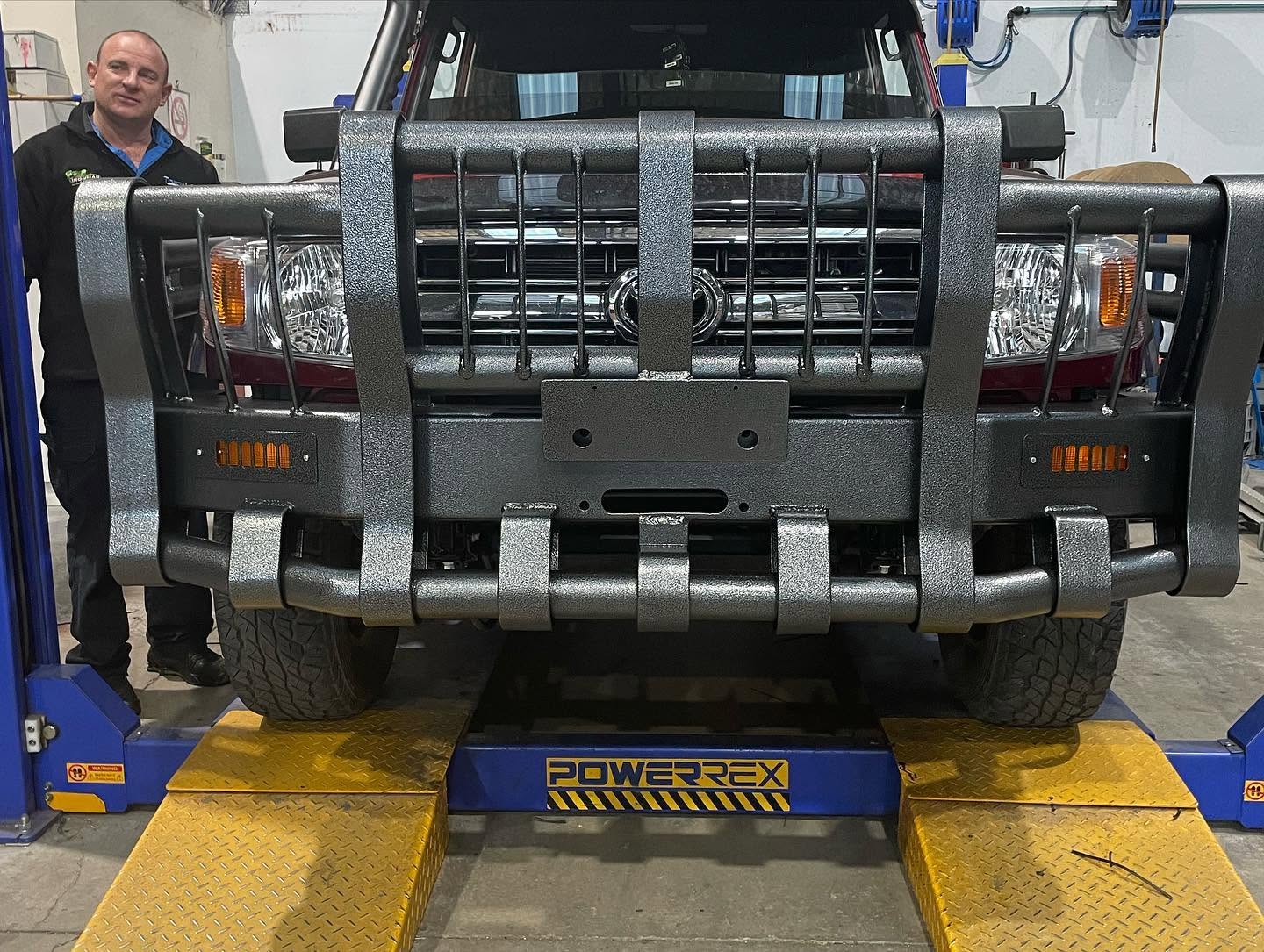 Textured grey steel bull bar fitted to a LandCruiser in the workshop